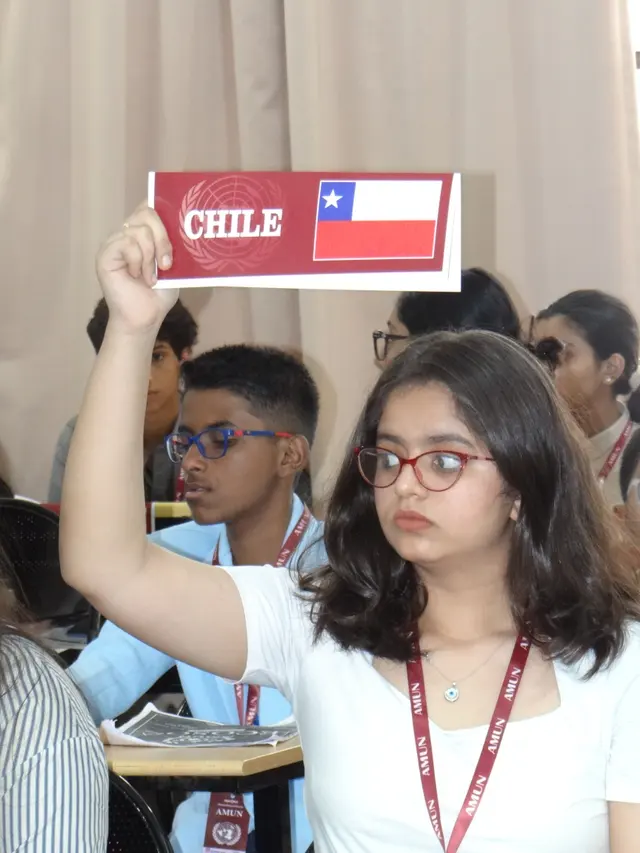 A delegate raises Chile’s placard to be recognised.