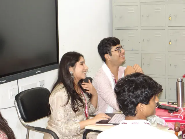 Two delegates laughing at their desks.