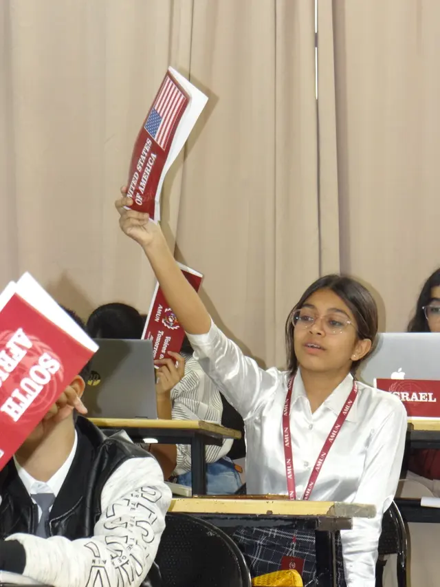 A hand goes up with the United States placard.