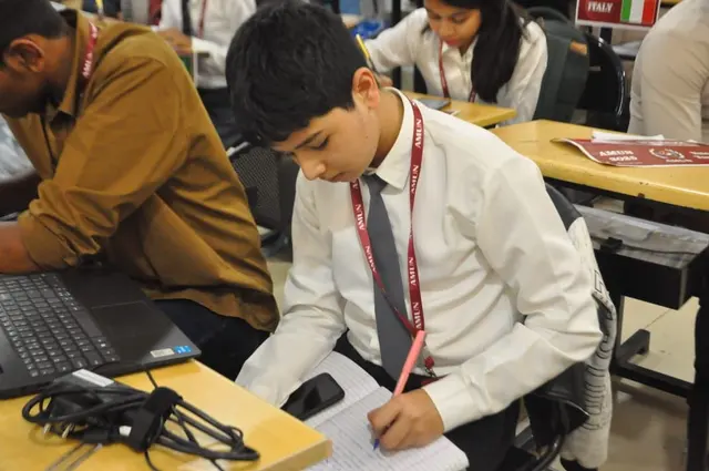 A delegate takes notes by hand during a session.