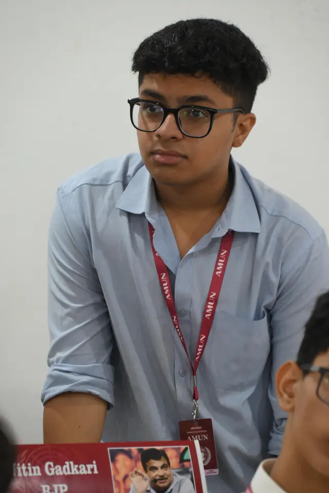 A delegate listens to the floor.