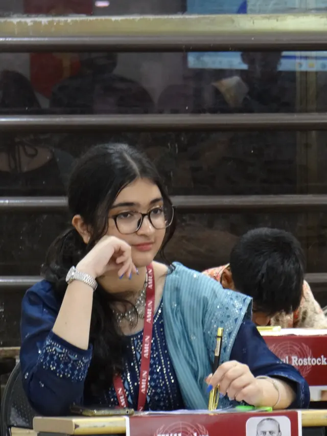 A delegate smiles during a session.