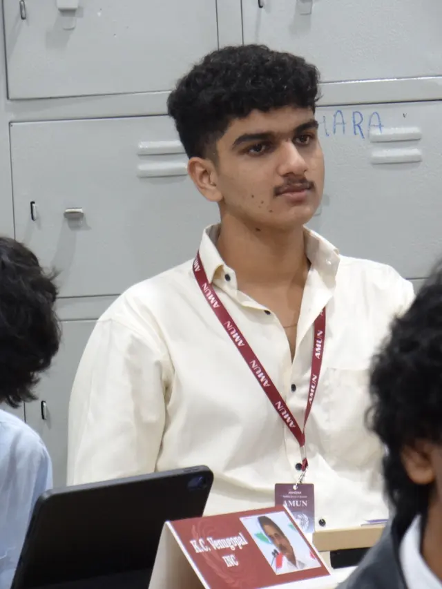 A delegate at a laptop between speeches.