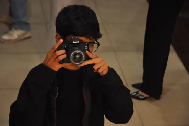 The conference photographer, caught on the other side of the lens.
