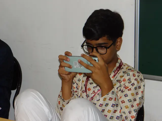 A delegate films the room on a phone.