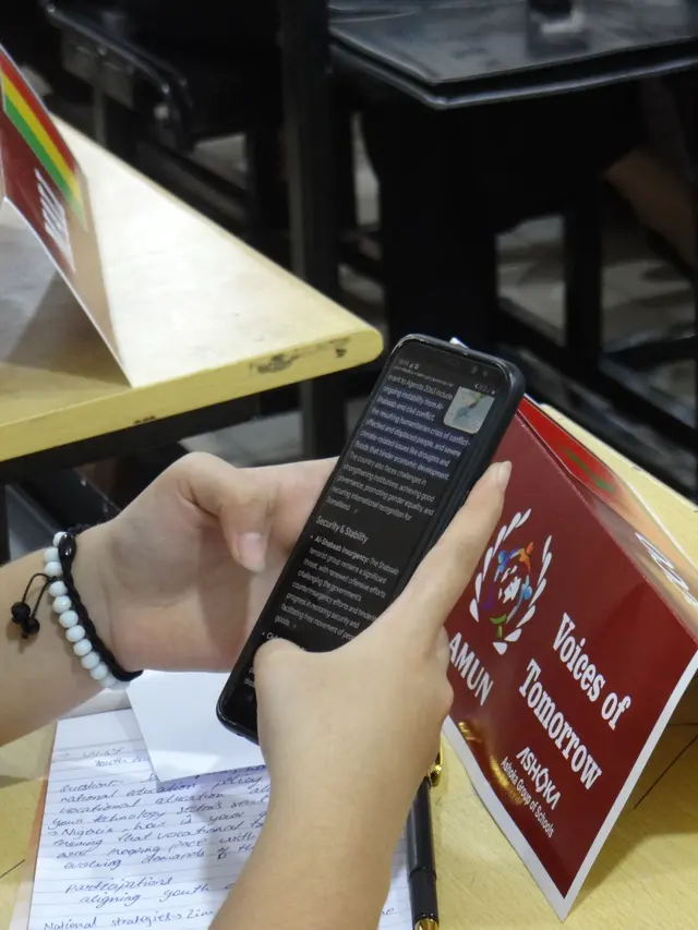 A placard and a phone on a delegate’s desk.